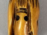 an image of a wooden mask with a horse ' s head on it