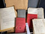 a lot of old books in a suitcase on the floor