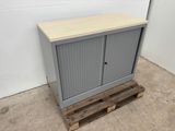 a grey cabinet with a wooden top sitting on a pallet