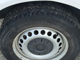a close up of a tire on the side of a white truck