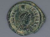 an old coin with a man on it sitting on a table