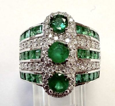 an image of a close up of a ring with emeralds and diamonds