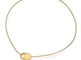a close up of a gold necklace with a disc on a white background