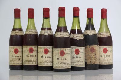 six bottles of wine are lined up in a row on a table
