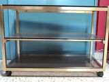 a metal cart that has three shelves on it