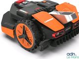 an image of a robotic lawn mower on a white background