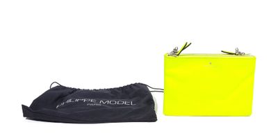 a yellow purse sitting next to a black bag on top of a white surface
