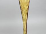 a glass vase that is sitting on top of a table