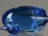 a blue glass bottle sitting on top of a table