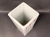 a small white square bowl with a design on it