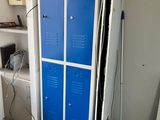 two blue lockers in the corner of a room