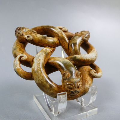 a sculpture of a snake wrapped around a piece of wood