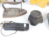 many different types of antique irons on the table