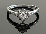 an image of a diamond ring on a reflective surface