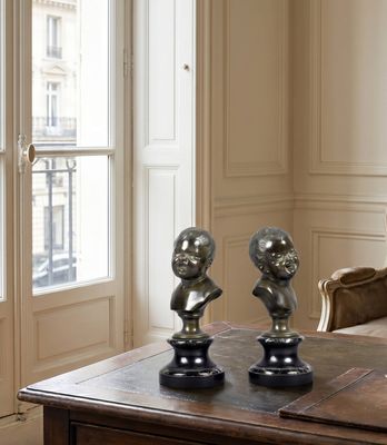 three busturines on a table in a living room