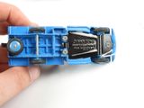 a person holding a blue toy car in their hand