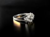 a close up of a diamond ring on a black surface