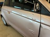 a silver car that is parked in a garage