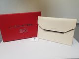 a red and white box with a white purse on top of it