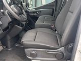 the interior of a van with the door open and the driver ' s seat down