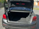 a car with its trunk open in the parking lot