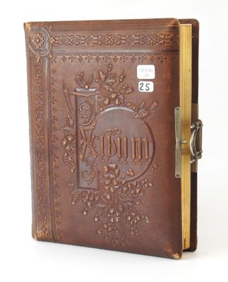 an old book with a lock on the front of it