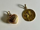 a pair of gold toned earrings with a coin on top