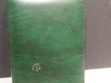 leather cover of a green book with a picture of a horse on it
