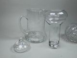 three glass vases and a glass pitcher on a table