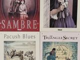 four books that are on display on the wall