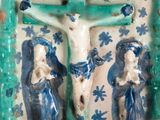 a blue and white vase with a crucif on it