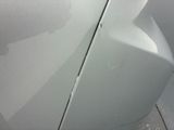 a close up of a car ' s front bumper with a dent