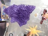 someone is holding a purple toy in a clear plastic box