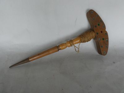 an old wooden stick with a wooden handle on a white surface