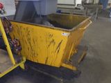 a yellow dumpster sitting in the middle of a warehouse