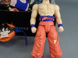 dragon ball action figure next to a box full of toys