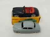 two toy cars sitting next to each other on a table