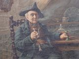 painting of a man sitting at a table with a bottle in his hand