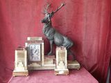 a statue of a stag on top of a clock
