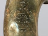 a close up of a brass vase with a label on it