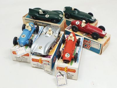 several toy cars are sitting in a box on a white surface