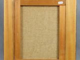 a wooden frame with a beige linen backing