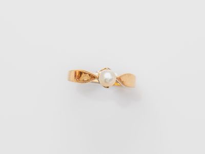 an image of a gold ring with a pearl in the center