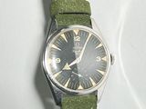 a watch that is sitting on a white surface