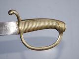 a close up of a sword with a gold handle