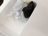 a stuffed animal in a box with tissue paper in it