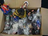 a cardboard box filled with dolls and other toys