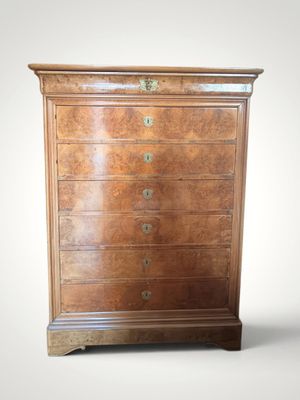 an antique chest of drawers with a wooden top and brass hardware