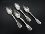 four silver spoons are lined up in a row on a black surface