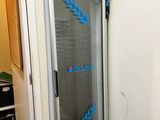 an image of a freezer in a room with a blue sticker on the door